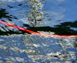 Red hose along water's surface