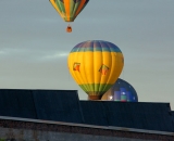 Hot air balloons rise above Bates Mill #5