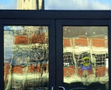 parking-garage-and-Basilica-reflected-in-courthouse-doors-Lewiston_DSC03309